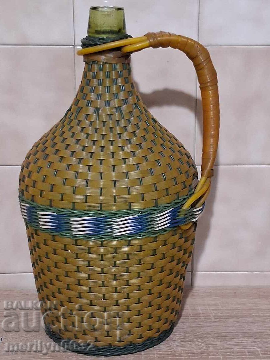 Old woven demijohn, bottle with weave, bottle, glass