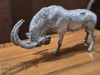 Two decorative metal sculptures of fighting goats!