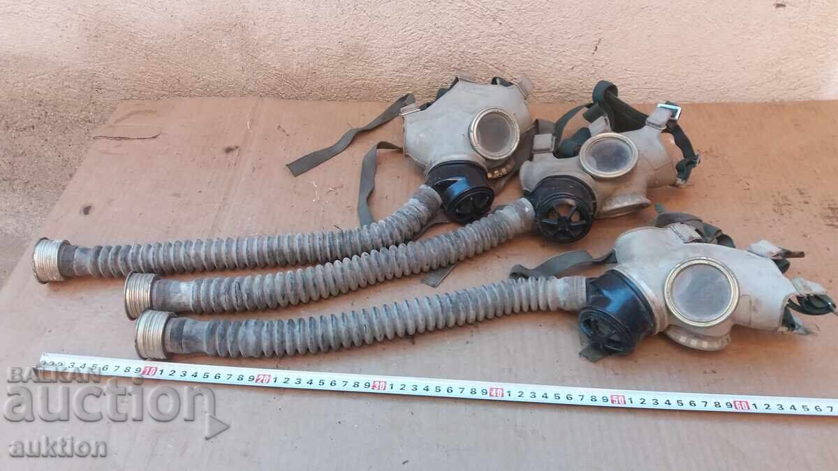 LOT OF THREE GAS MASKS WITH HOSES