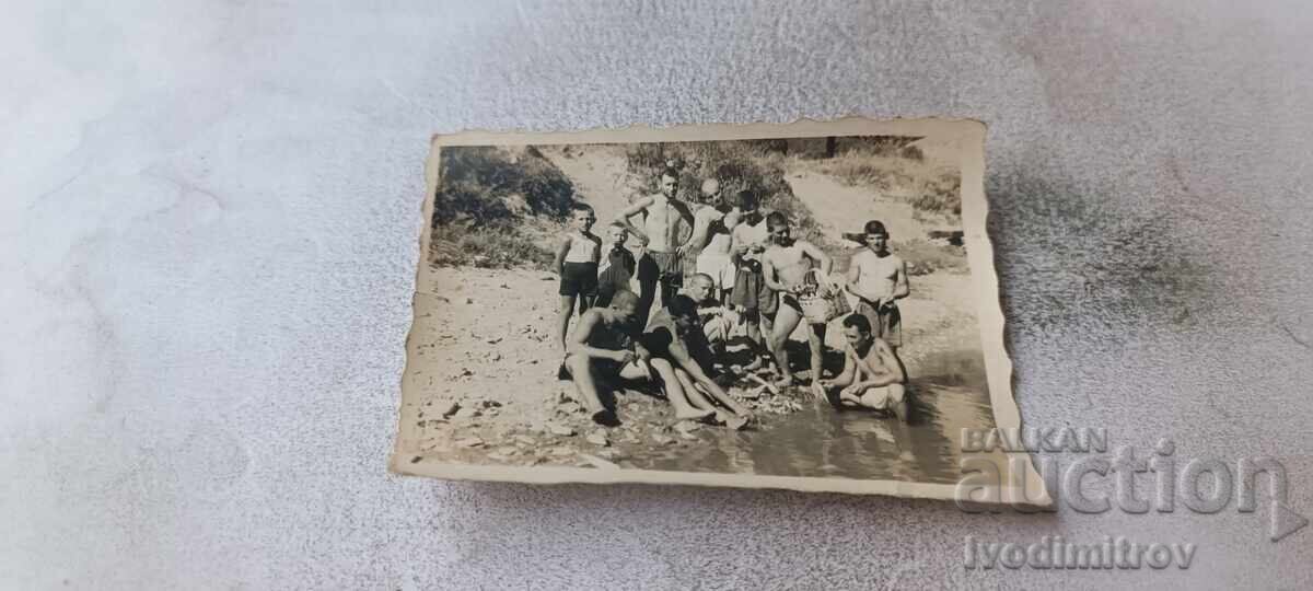 Photo Men and youths on the riverbank
