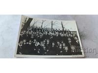 Photo: Students with teachers and a man with orders and medals