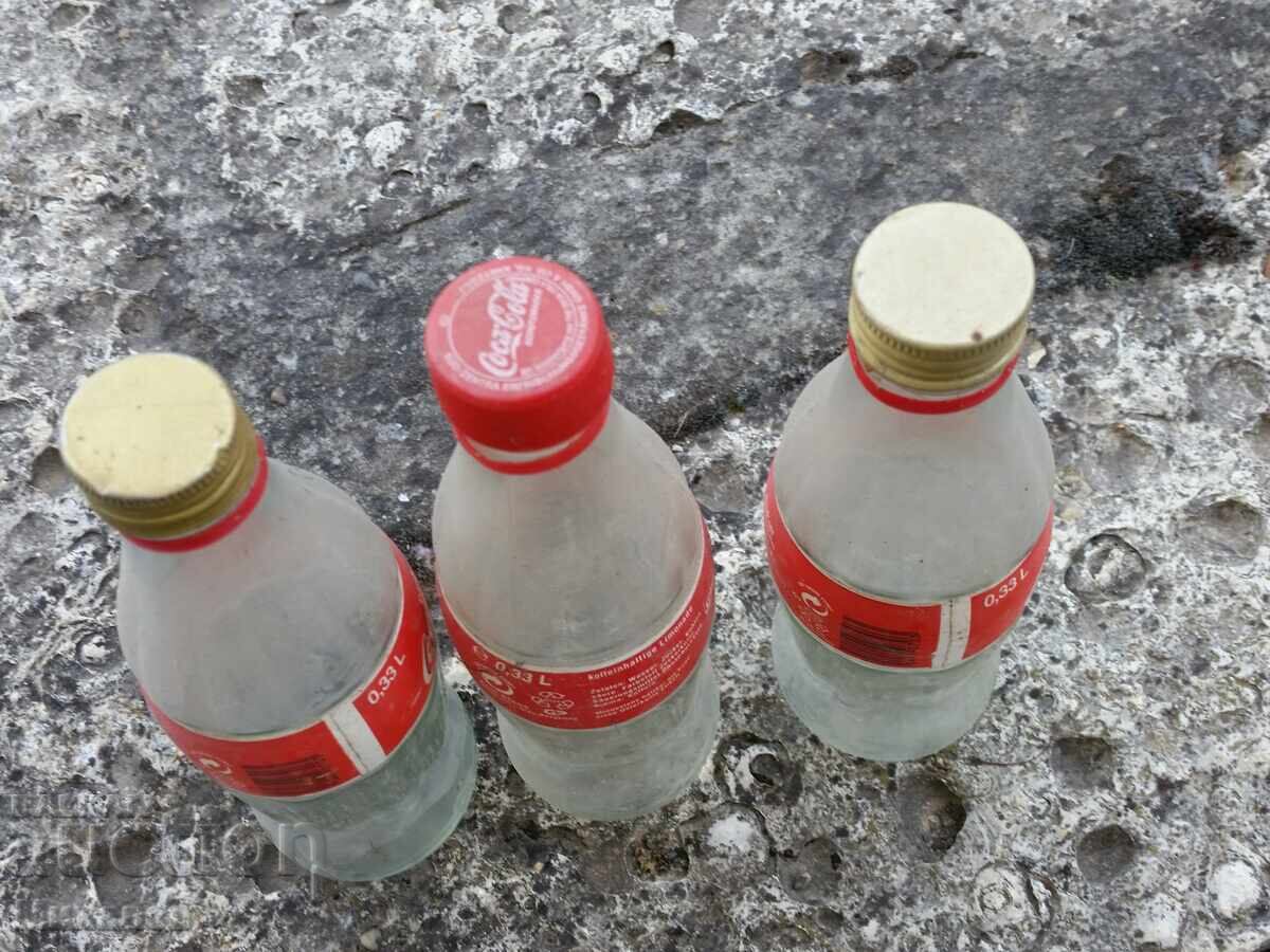 three Coca-Cola glass bottles with price € 0.01 | 0.02 BGN