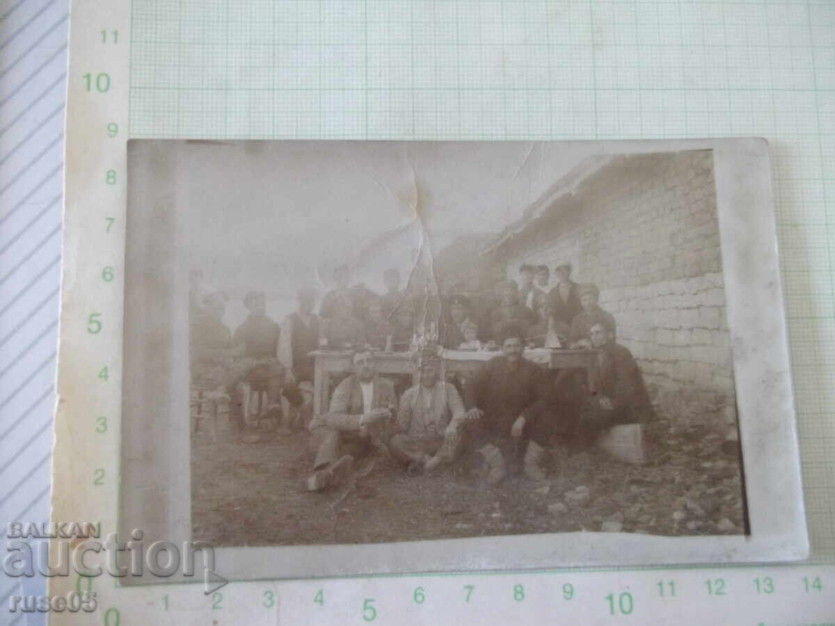 Снимка на група мъже на маса пред къща стара