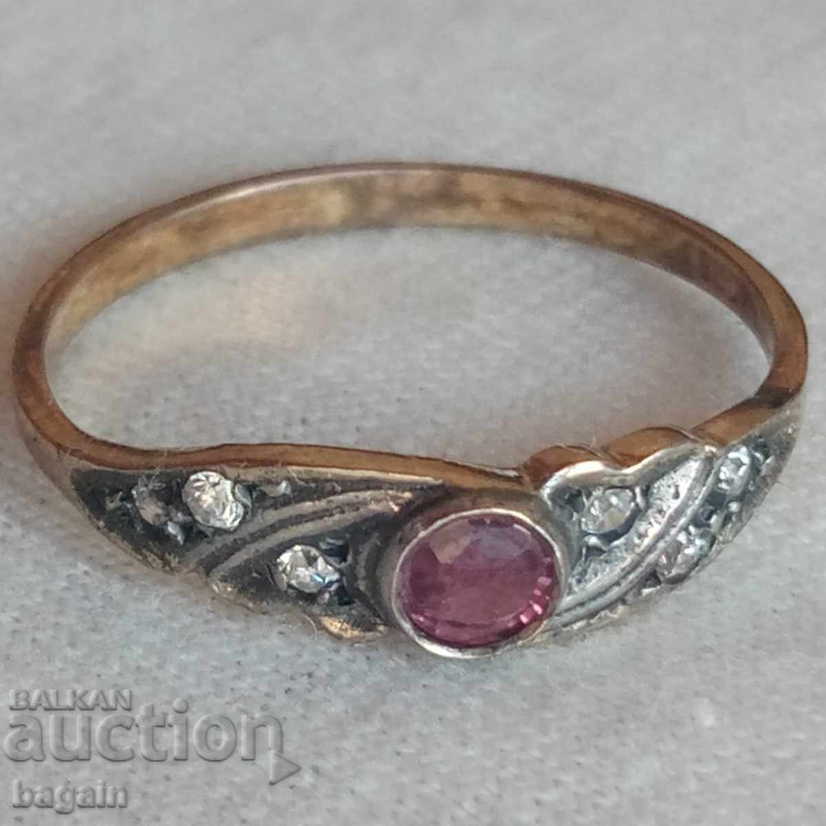 Beautiful silver ring with ruby, zircons, and gold plating