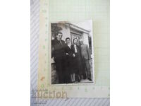 Photo of two families in front of an old building