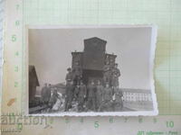 Photo of soldiers in front of an old train carriage