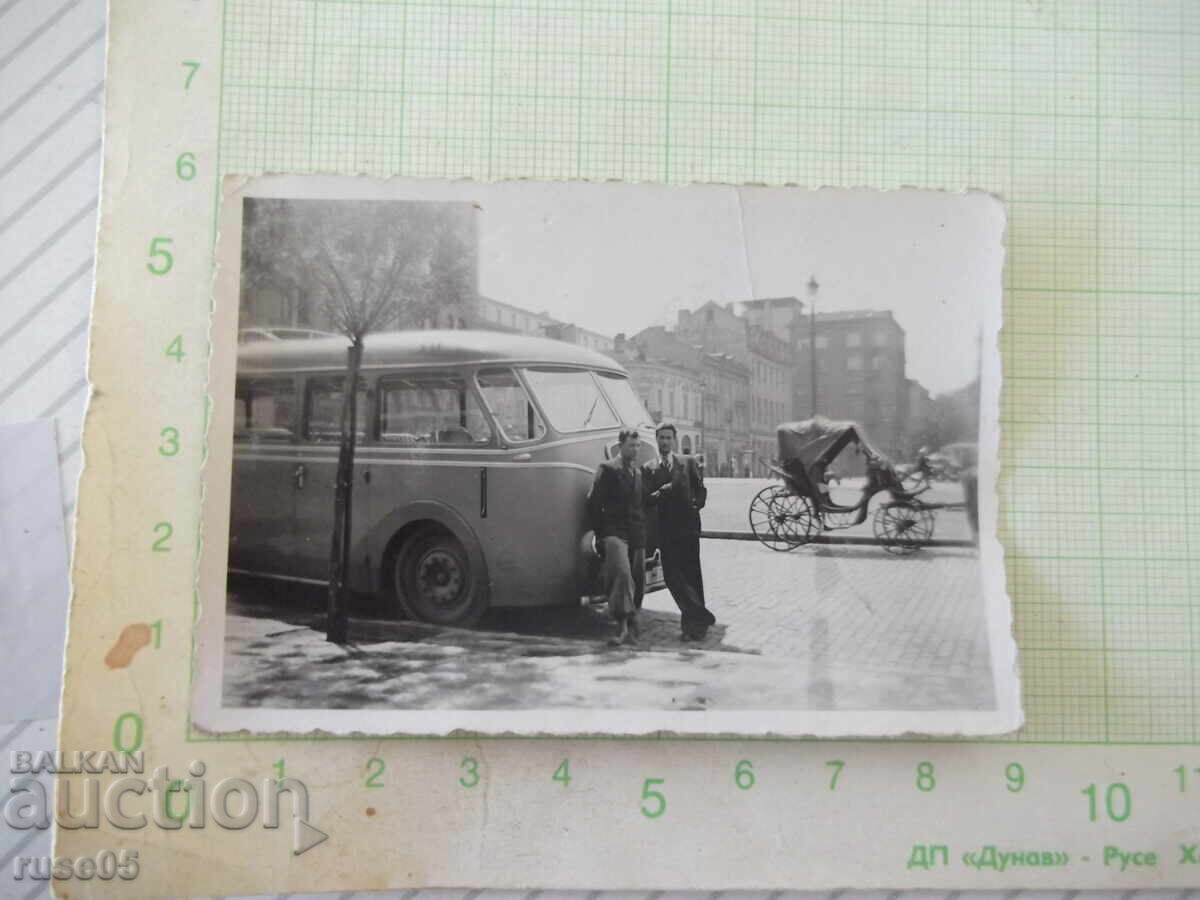 Photo of two men in front of an old bus old