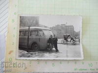 Photo of two men in front of an old bus old