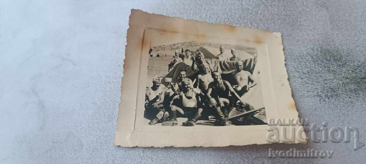 Photo Soldiers naked to the waist in front of tents