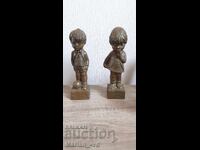 Bronze resin sculptures of a little girl and boy