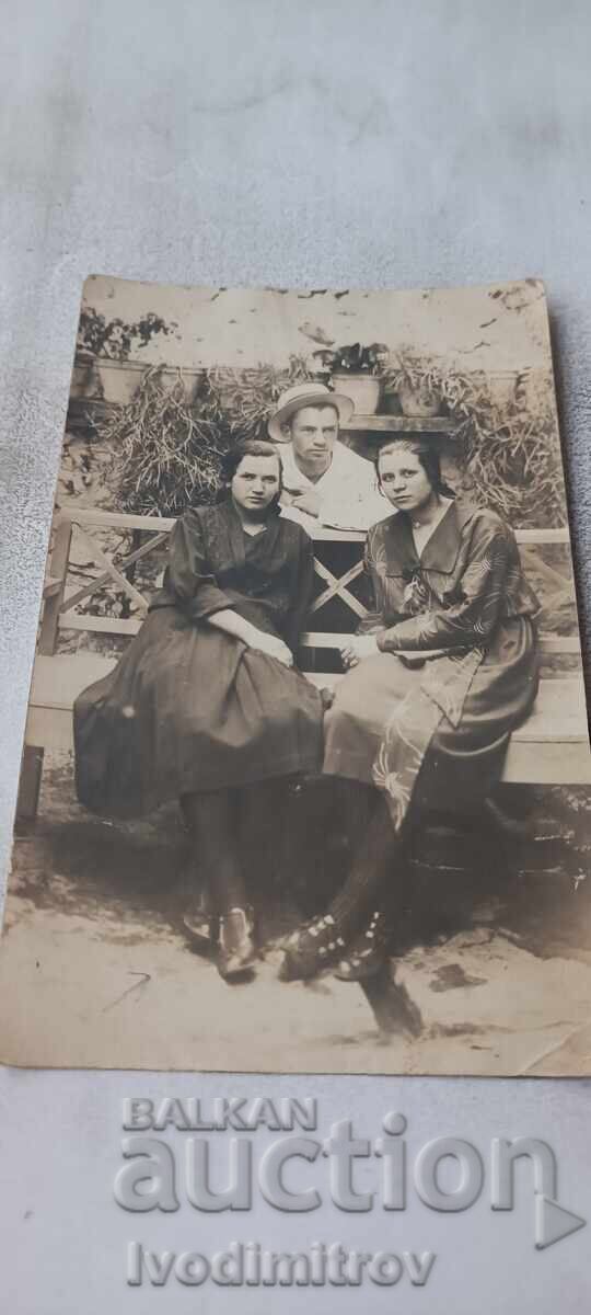 Photo Youth and two young girls on a wooden bench 1923 Photo Youth and two young girls on a wooden bench 1923