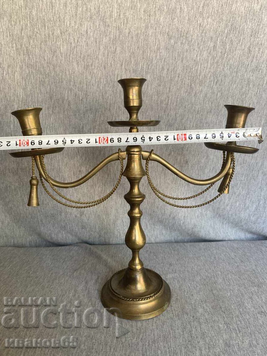 Auction Brass candlestick with decorative ropes and tassels Auction Brass candlestick with decorative ropes and tassels