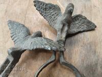 Two old bronze eaglets