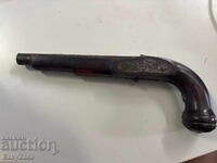 Old wooden stock with barrel for a retro pistol / flintlock pistol
