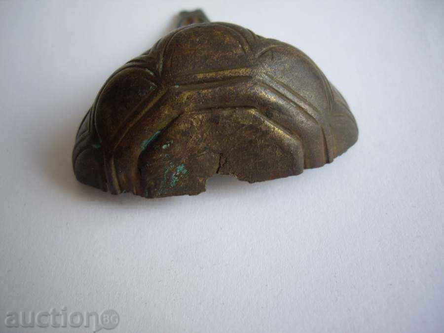 Auction Bronze part of the handle of an old gun. Auction Bronze part of the handle of an old gun.