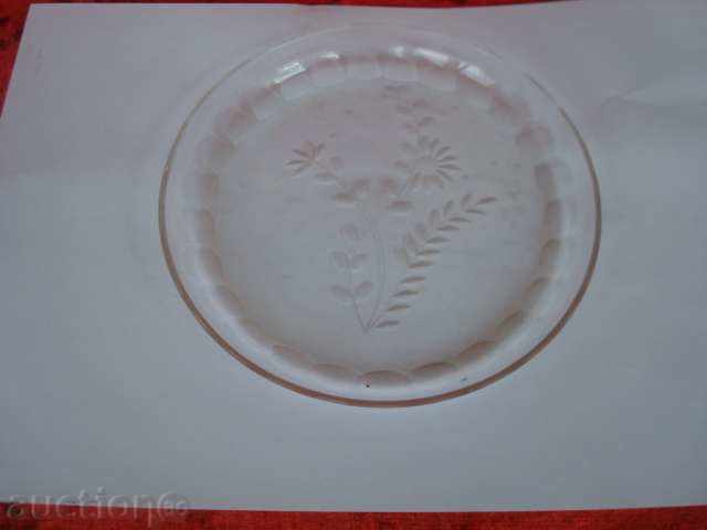 Old plate with engraved floral elements.