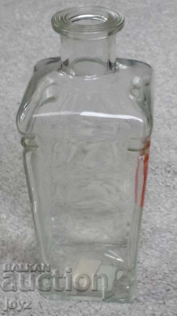 Παράδοση Μια αρχαία ελληνική γυάλινη φιάλη για αλκοόλ Παράδοση Μια αρχαία ελληνική γυάλινη φιάλη για αλκοόλ