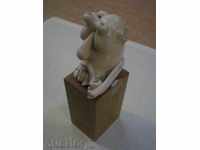 Porcelain figure of a wooden pedestal