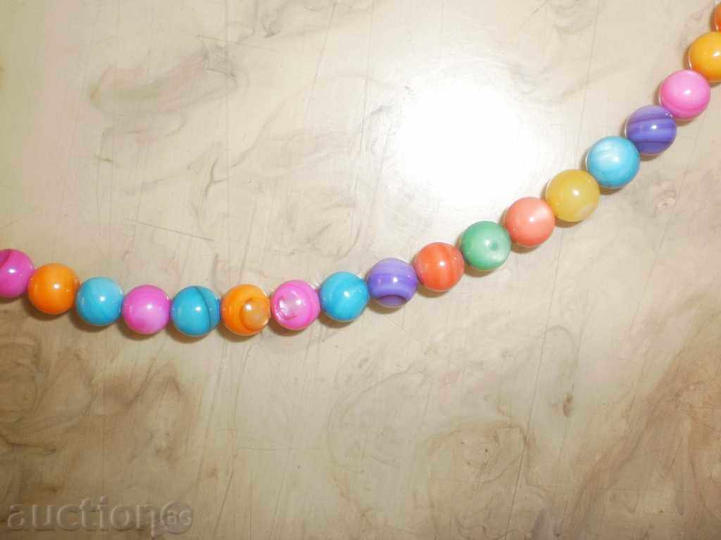 Auction Necklace of natural multi-colored mother-of-pearl with a round shape Auction Necklace of natural multi-colored mother-of-pearl with a round shape