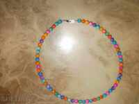 Necklace of natural multi-colored mother-of-pearl with a round shape