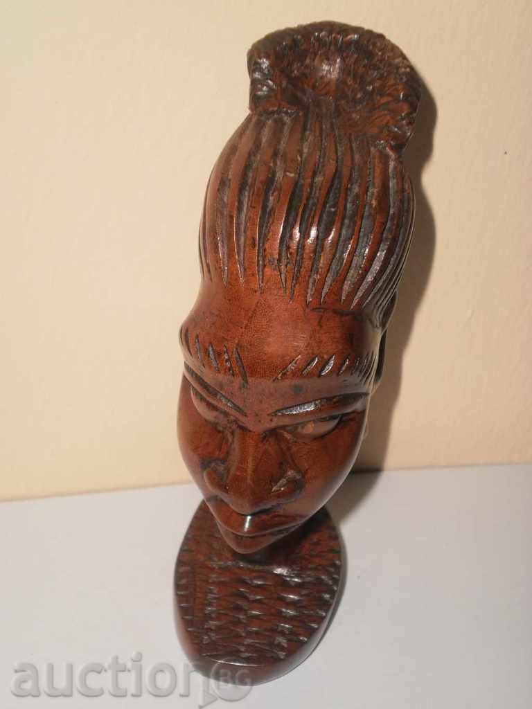 Auction  Head of a woman with an authentic ebony hairstyle