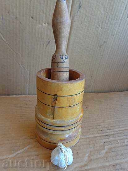 Old wooden mortar with hammer, mortar, wooden