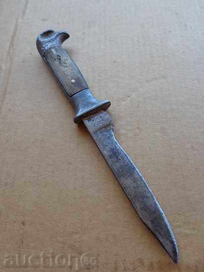 An old knife with an eagle head and a buffalo horn, a dagger