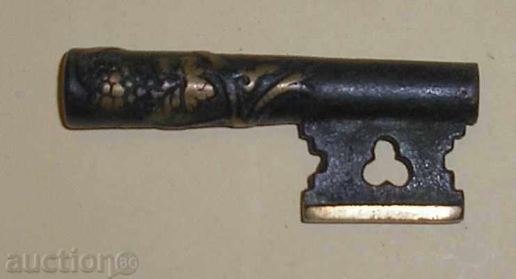 A piece of old bronze key