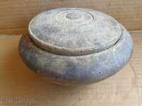 An old wooden bowl with a lid, a cop, a wooden one