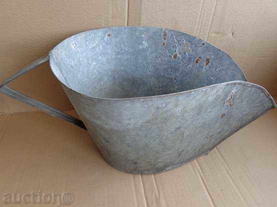 An old galvanized basin, trough, pot, household pot