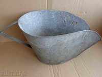 An old galvanized basin, trough, pot, household pot