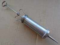 Old metal syringe, horsepower injection