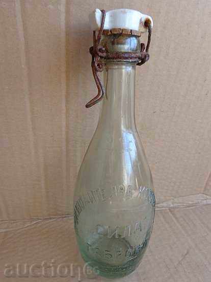 An old bottle with a porcelain stopper, a bottle
