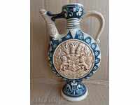 Ceramic pot, pottery, crown, burette, bake a jug with a coat of arms