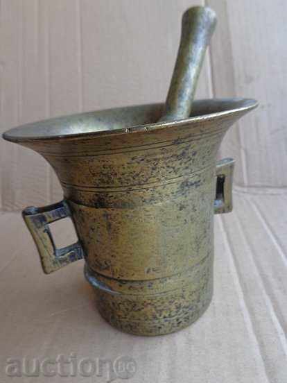 An old bronze mortar with a hammering mortar