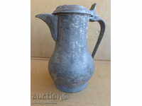 An old tin pipe with a lid, a copper pot, a crown jug