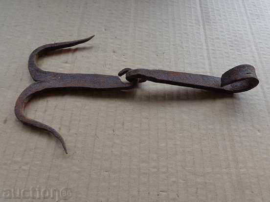 An old forged hook for scraping, a cock, anchor