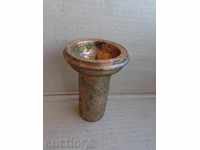 An old copper candlestick, a copper pot, a baker