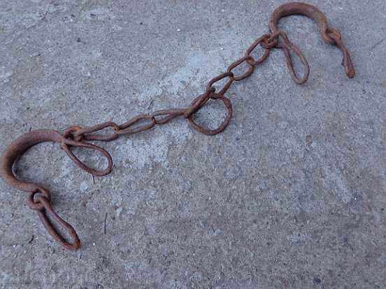 Old hand-forged shackles, chains, fetters, iron shackles Old hand-forged shackles, chains, fetters, iron shackles