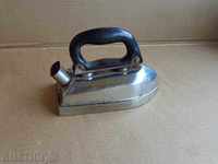 Old electric iron with a handle of bakelite, an early salt,