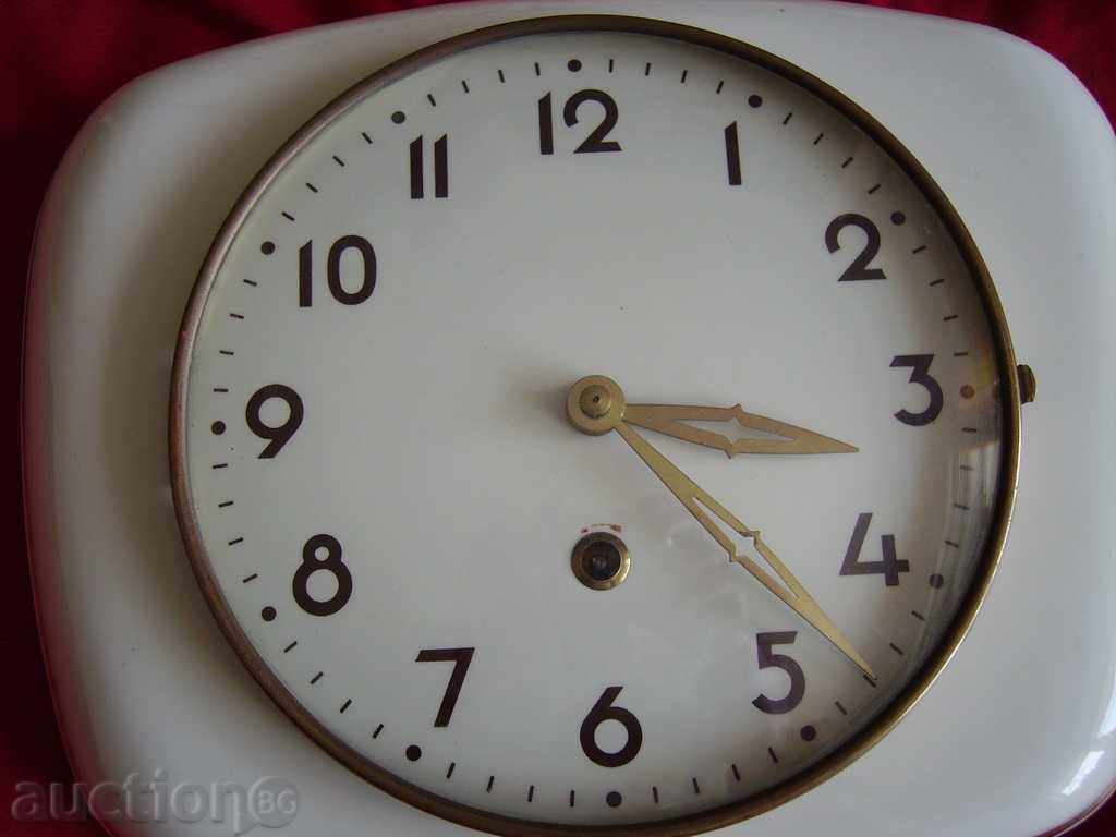 Auction  An old clocked mechanical clock porcelain dial and housing