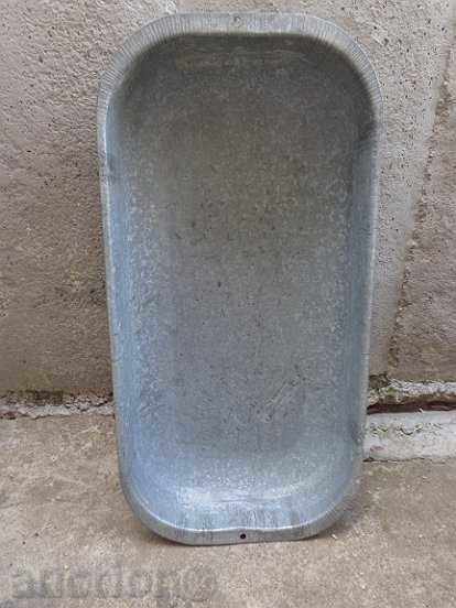 An old galvanized bed, a household bowl