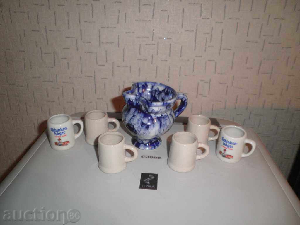 Porcelain cups and brandy jug