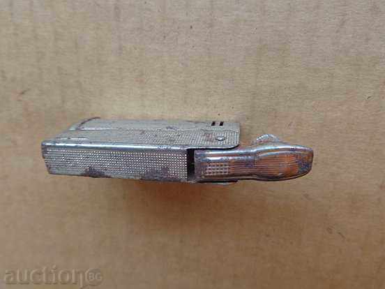 Auction  An old gas lighter works