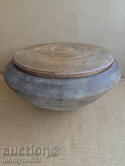 An old wooden bowl with a lid, a chimney, a wooden pot