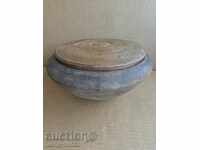 An old wooden bowl with a lid, a chimney, a wooden pot