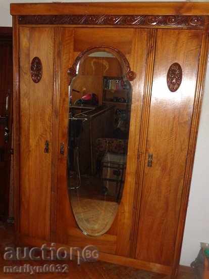 Old wardrobe made of walnut wood carving Venetian mirror