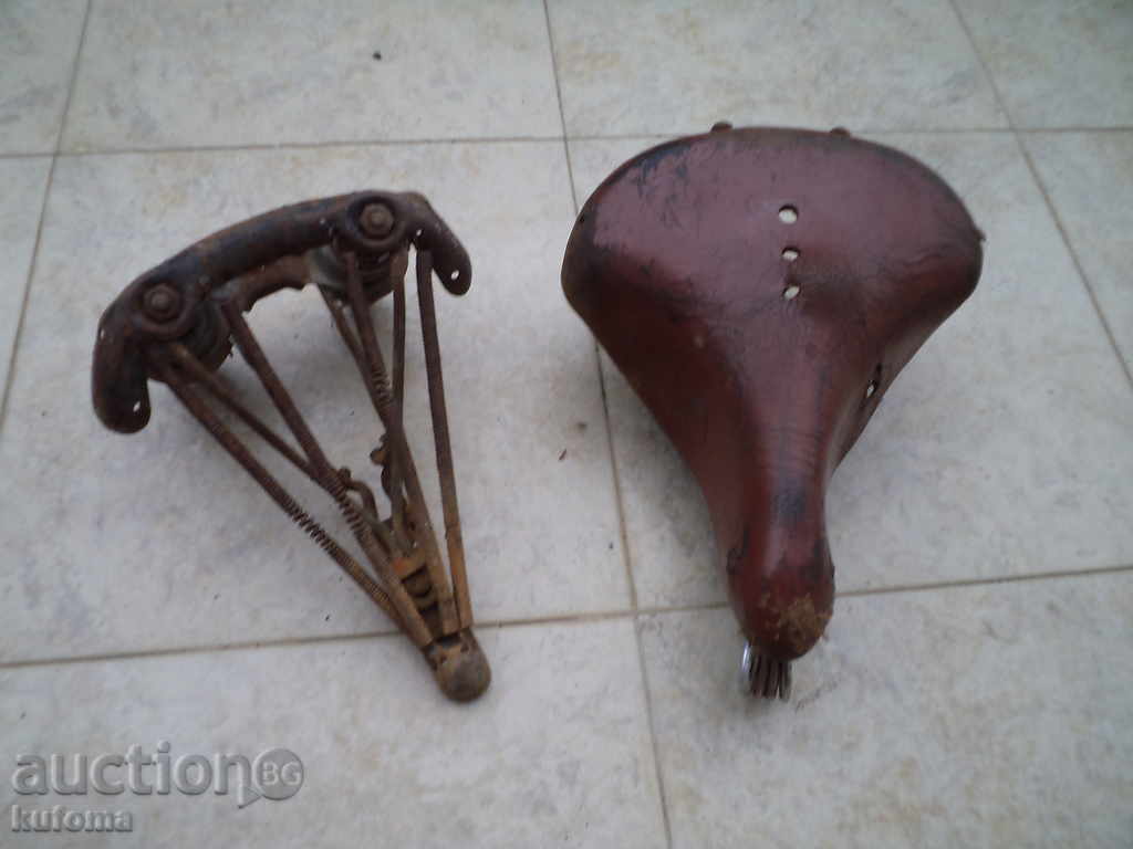 2 old bicycle or motorbike seats