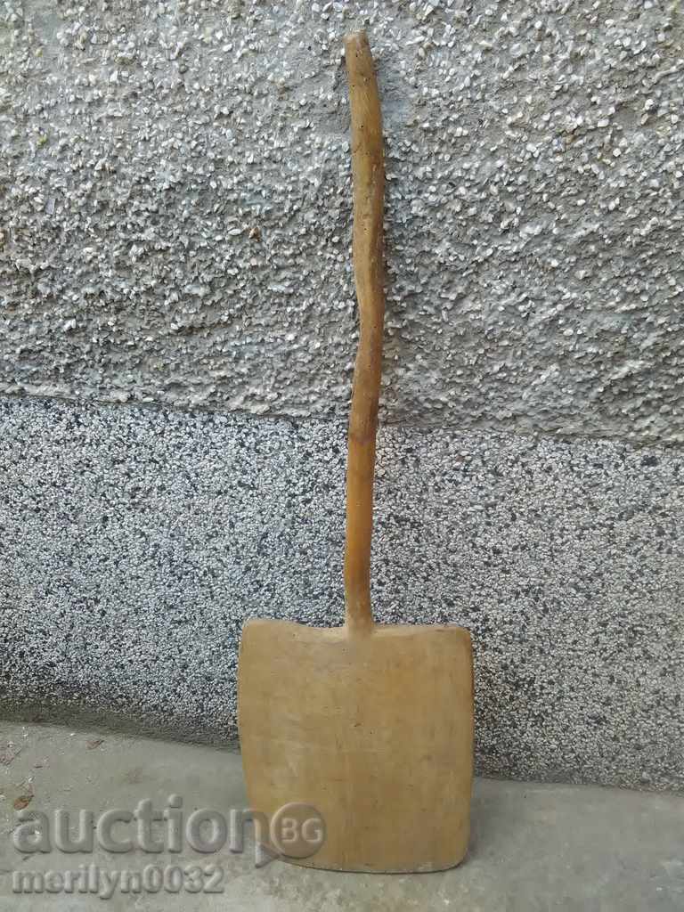 An old wooden shovel, a blade, a wood-burning wood