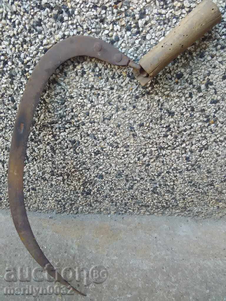 An old sickle with a seal, a knife, a blade, a wrought iron